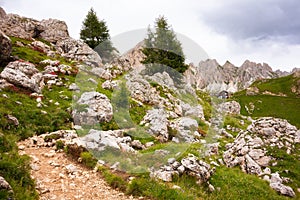 Mountain hiking trail with people walking in Dolomite alps