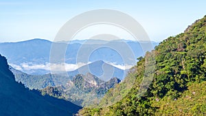 Mountain hill in the forest with blue sky and white cloud for hiking traveller at Chiangdao, Chiangmai, Thailand.