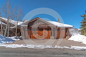 Mountain home with glass paned brown wooden garage door in Park City Utah