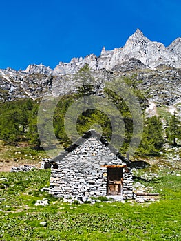 mountain hut landscape view in the spectacular angles of the devero alp on a sunny day, Lepontine Alps, summer mountain landscape