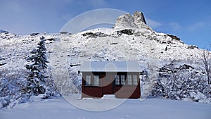 Mountain hut near Visitor centre on Trollstigen in snow in Norway in autumn