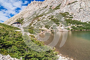 Mountain hut Refugio Frey and Laguna Toncek lake photo