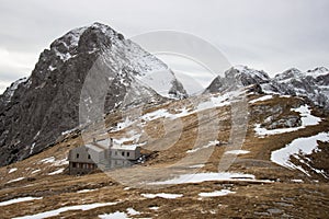 Mountain hut in snowy alpine landscape photo