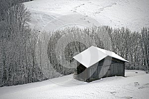 Mountain hut in winter landscape