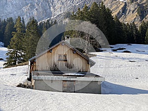 Mountain huts chalets or farmhouses and old wooden cattle houses in the alpine valley of KlÃ¶ntal or Kloental - Switzerland