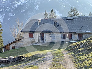 Mountain huts chalets or farmhouses and old wooden cattle houses in the alpine valley of KlÃ¶ntal or Kloental - Switzerland