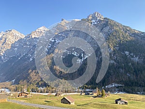 Mountain huts chalets or farmhouses and old wooden cattle houses in the alpine valley of KlÃ¶ntal or Kloental - Switzerland