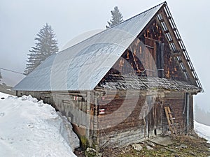 Mountain huts chalets or farmhouses and old wooden cattle houses in the valley of WÃ¤gital or Waegital and by the alpine Lake