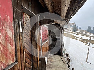 Mountain huts chalets or farmhouses and old wooden cattle houses in the valley of WÃ¤gital or Waegital and by the alpine Lake