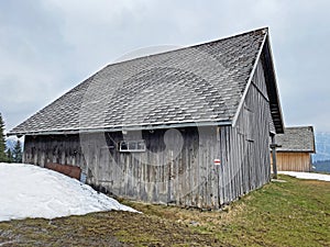 Mountain huts chalets or farmhouses and old wooden cattle houses in the valley of WÃ¤gital or Waegital and by the alpine Lake