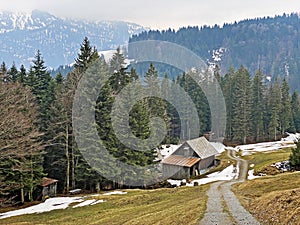 Mountain huts chalets or farmhouses and old wooden cattle houses in the valley of WÃ¤gital or Waegital and by the alpine Lake