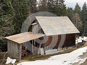 Mountain huts chalets or farmhouses and old wooden cattle houses in the valley of WÃ¤gital or Waegital and by the alpine Lake