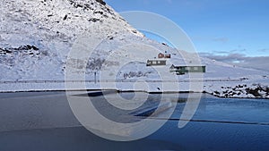 Mountain huts near Visitor centre on Trollstigen road in snow in Norway in autumn