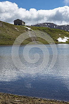 Lake Scaffaiolo and its reflections in May photo