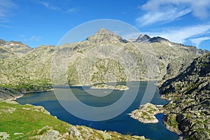 Mountain lake called Embalse Bachimana in Pyrenees on a hiking trail GR11/HRP in Spain