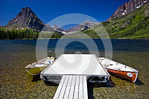 Mountain lake with canoes and dock