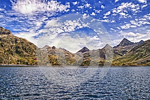 Mountain Lake Landscape. Mountain Range panorama with beautiful clouds in blue sky