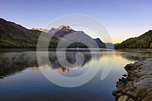 Mountain lake panorama with mountains reflection. Idyllic look. Autumn forest. Silvaplana Lake,