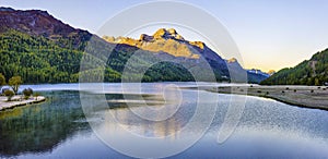 Mountain lake panorama with mountains reflection. Idyllic look. Autumn forest. Silvaplana Lake,