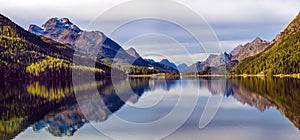 Mountain lake panorama with mountains reflection. Idyllic look. Autumn forest. Silvaplana Lake,