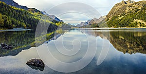 Mountain lake panorama with mountains reflection. Idyllic look. Autumn forest. Silvaplana Lake,