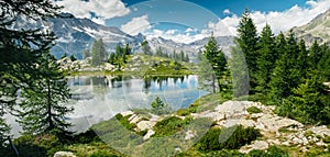 Mountain lake reflectiion landscape with green trees around. Sense of freedom. Gran Paradiso National Park, Bellagarda