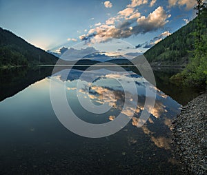 Mountain lake with reflection in the evening