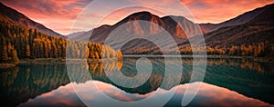 Mountain lake at sunset with reflection in water. Panoramic view.