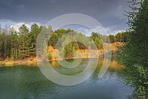 Mountain lake surrounded by forest. Spring landscape