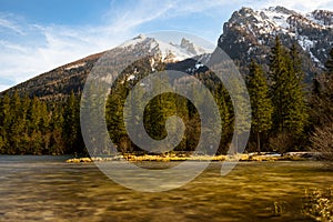 Mountain lake in thae Bavarian Alps in spring and snow on the mountains.