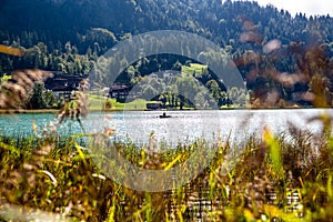 The mountain lake Thiersee in Tyrol, Austria. Boat with Fisherman on lake. photo