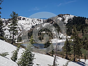 Mountain lake with trees and snow