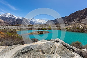 Mountain lake under the sunny day with blue sky along Karakorum Highway in Passu, Hunza district