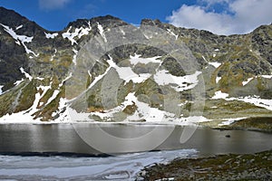 The mountain lake Vel`ke Hincovo pleso with the Mengusovske mountains in the High Tatras