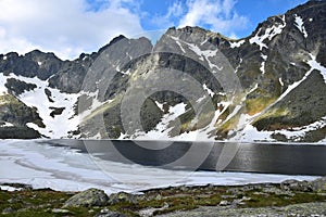 The mountain lake Vel`ke Hincovo pleso with the Mengusovske mountains in the High Tatras