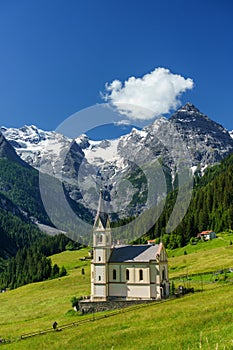 Mountain landscape along the road to Stelvio pass at summer. Church