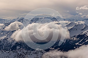 Mountain landscape in the Alps - white clouds between the peaks