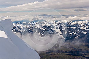 Mountain landscape in the Alps - white clouds between the peaks