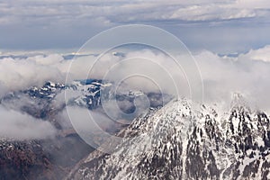 Mountain landscape in the Alps - white clouds between the peaks