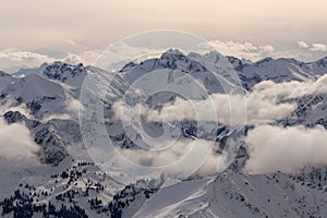 Mountain landscape in the Alps - white clouds between the peaks