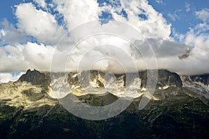 Mountain landscape of amazing view over valley to snow capped mountain covered in low cloud