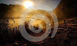 Mountain landscape with autumn morning fog at sunrise