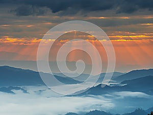 Mountain landscape with colorful vivid sunset on the cloudy sky