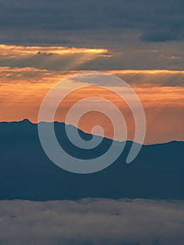 Mountain landscape with colorful vivid sunset on the cloudy sky