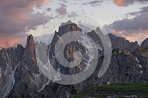 Mountain landscape in the European Dolomite Alps underneath the Three Peaks with alpenglow during sunset, South Tyrol Italy