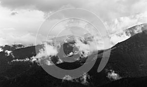 Mountain landscape with foggy clouds in a black and white interpretation, in Transalpina, Parang Romania
