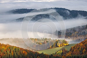 Mountain landscape with foggy valley during autumn morning