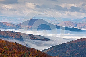 Mountain landscape with foggy valley during autumn morning