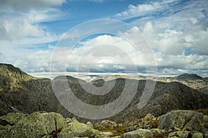 A mountain landscape with a Folgefonna glacier in the distance. A distant scenery of ice.