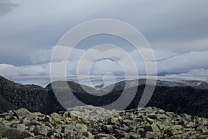 A mountain landscape with a Folgefonna glacier in the distance. A distant scenery of ice.